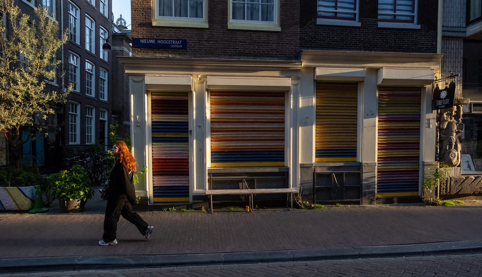 Shuttered storefront in Amsterdam at golden hour